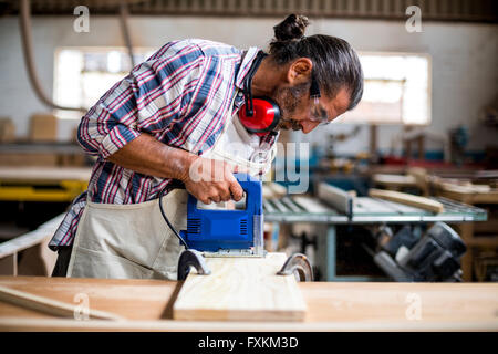 Carpenter usando un seghetto alternativo Foto Stock