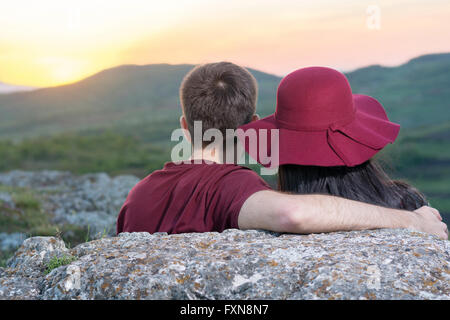 Giovane godendo di un romantico tramonto su un viaggio escursionistico Foto Stock