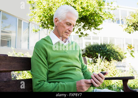 Senior uomo texting qualcuno Foto Stock