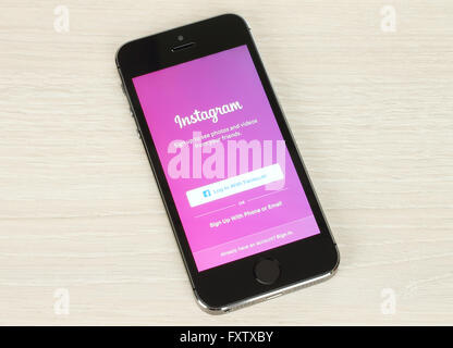 Kiev, Ucraina - 20 Gennaio 2016:iPhone con Instagram nella pagina di login sul suo schermo su sfondo di legno Foto Stock