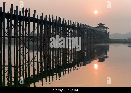 Tramonto sull'U Bein ponte che attraversa il lago Taungthaman, la più lunga passerella in legno di teak nel mondo Foto Stock