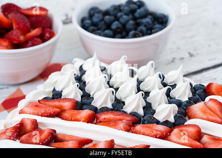 Patriottica bandiera americana torta. Bocce di mirtilli e fragole in background. Foto Stock
