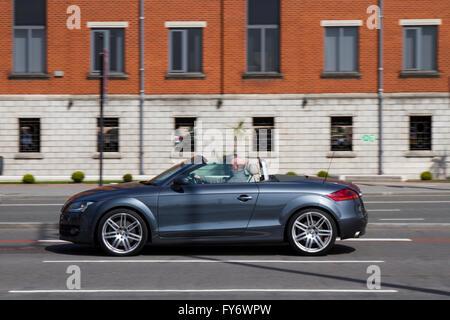 Blu grigio Audi TT ConvertibleTraffic, vista laterale motion blur automobile che viaggia su "Strand' l'autostrada principale attraverso la parte anteriore del Liverpool City, adiacente al dockland e le principali attrazioni turistiche, Merseyside, Regno Unito Foto Stock