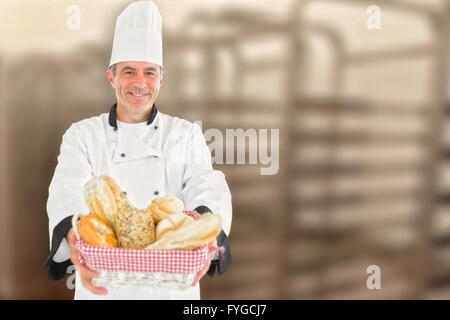 Immagine composita dei maschi di chef holding pane fresco nel cestino Foto Stock