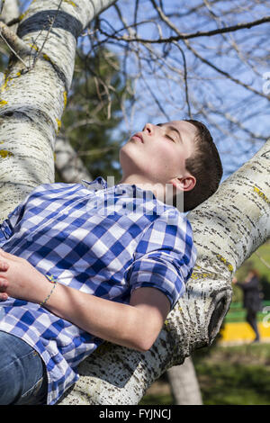 Il Relax.Un ragazzo giovane vestito in costumi occidentali, parco all'aperto, estate Foto Stock