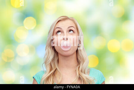 Felice giovane donna o ragazza adolescente gomme da masticare Foto Stock