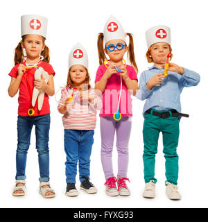 I bambini con cappucci di medico e di medico giocattolo strumenti Foto Stock