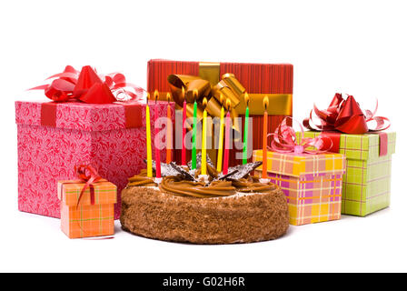 Torta con dieci candeline e doni in scatole su sfondo bianco Foto Stock