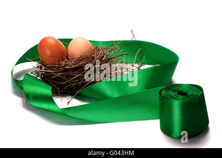 Simgera di uova in nidi e nastri verdi Foto Stock