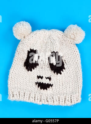 Maglia di lana hat con un modello di poco i volti Foto Stock