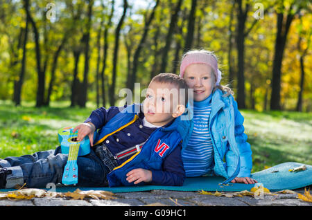 Carino piccolo fratello e sorella a giocare all'aperto Foto Stock