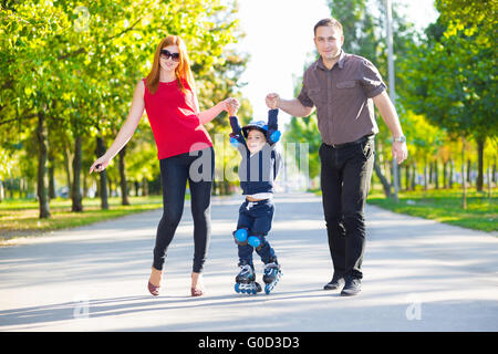 Felice il padre e la madre tenendo il loro figlio Foto Stock