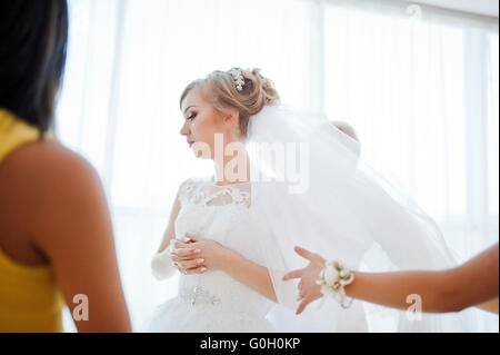 Dolce sposa bionda con damigelle in abito giallo Foto Stock