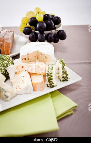 Il piatto di formaggi con uva e vino a cena Foto Stock