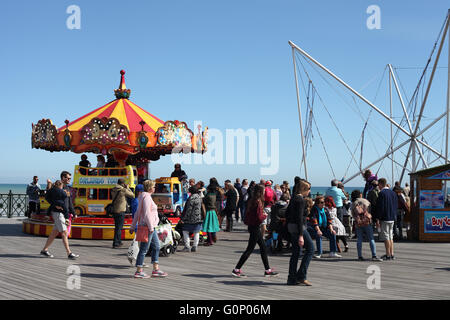 Bambini godendo di un giro sulla giostra su Hastings nuovo molo, Hastings, East Sussex, Regno Unito Foto Stock