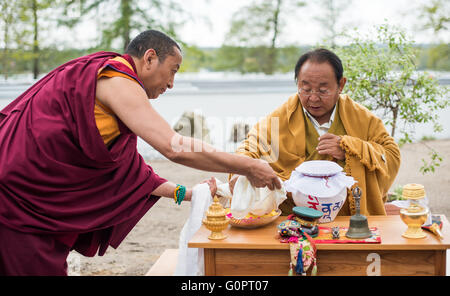 Bad Saarow, Germania. 04 Maggio, 2016. Sogyal Rinpoche (R), il Tibetano maestro di meditazione e il maestro della tradizione Nyingma del buddhismo tibetano, e Lama Yonten (L) condurre una cerimonia di apertura del Sukhavati spirituale Centro di cura a Bad Saarow, Germania, 04 maggio 2016. Il 'Sukhavati' centro buddista sarà aperto il Mercoledì con una benedizione cerimoniale da studioso Sogyal Rinpoche. Il bianco edificio complesso è costruito su un 8.000 metri quadrati sul sito Scharmuetzel lago nel centro della città. Foto: PATRICK PLEUL/dpa/Alamy Live News Foto Stock