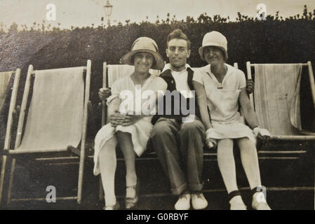 Storica fotografia in bianco e nero Uomo e due donna seduta sulla sdraio in estate Foto Stock