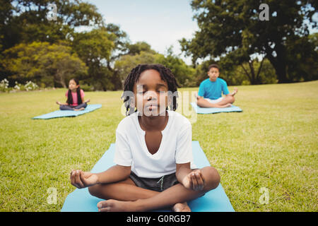 Ritratto di bambini a praticare lo yoga con gli amici Foto Stock