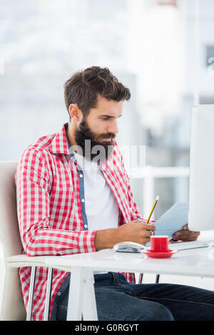 Hipster uomo leggendo le sue note Foto Stock