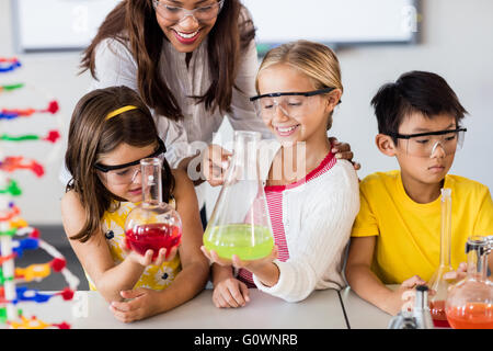 Docente aiutare gli studenti a fare scienza Foto Stock