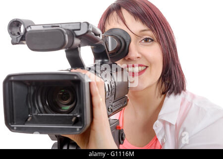 Un grazioso camerawoman con una fotocamera professionale, su bianco Foto Stock