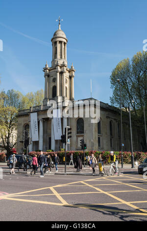 Un ciclista passa Santa Trinità chiesa edificio sulla trafficata Marylebone Road a Londra, Regno Unito Foto Stock