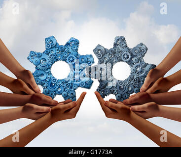 Lavoro di squadra aziendale e business a livello globale il concetto di cooperazione come due gruppi di diverse persone uniscono tenendo un ingranaggio gigante Foto Stock