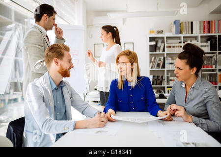 La gente di affari e architetti per discutere dei piani per il futuro Foto Stock