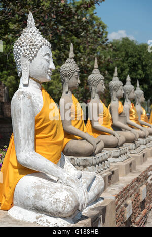 Fila di statue di Buddha di Wat Yai Chai Mongkhon tempio in Ayutthaya, Thailandia Foto Stock