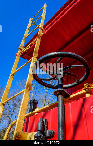 Close up della scala e il freno ruota di un restauro di un convoglio ferroviario caboose auto. Foto Stock