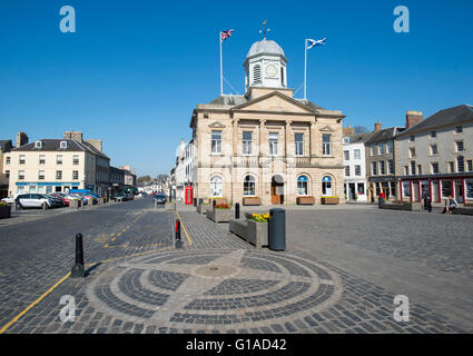 La Old Bull Ring impostato della pavimentazione della piazza del mercato di Kelso e municipio dietro. Foto Stock