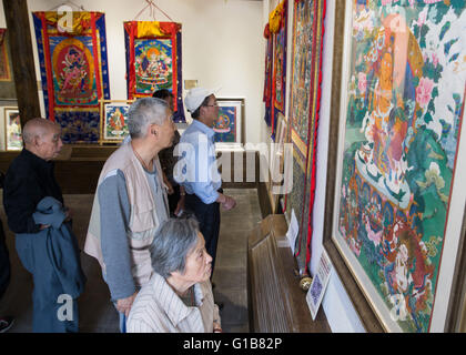 Nanjing, Nanjing, CHN. Il 12 maggio 2016. Nanjing, Cina - 12 Maggio 2016: (solo uso editoriale. Cina OUT ) mostra Thangka dalla contea Gongka Mozhu Yibet in Nanjing il Giardino di Yu. Un thangka, variamente spelta come tangka, thanka o tanka (pronuncia nepalese: [?t??un?ka]; il Tibetano: ?????; Nepal Bhasa: ????) è un buddista tibetano dipinto su cotone o seta appliquÂ¨â ¦, solitamente raffigurante una divinità buddista, scena o mandala. Thangkas sono tradizionalmente mantenuto privo di cornice e arrotolato quando non è sul display, montato su un supporto di materie tessili un po' in stile cinese dipinti di scorrimento, con un ulteriore coperchio di seta Foto Stock