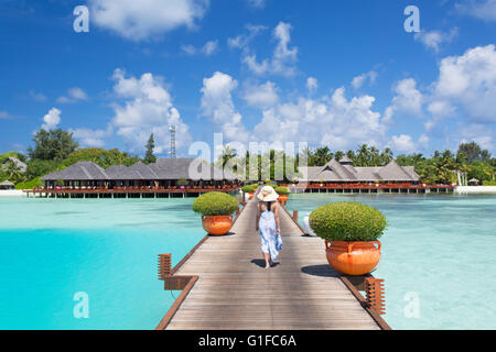 Donna sul molo Olhuveli Beach and Spa Resort South Male Atoll, Kaafu Atoll, Maldive Foto Stock