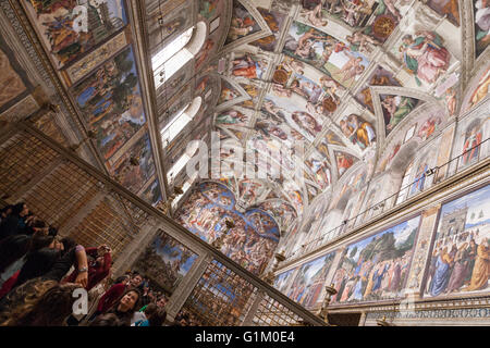 Turistica prendendo immagini per la creazione di Adamo di Michelangelo soffitto della Cappella Sistina. Foto Stock