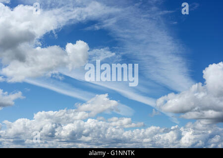 Estate formazioni di nubi con cielo blu e sentieri di vapore Foto Stock