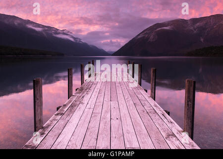 Iconico South Island, in Nuova Zelanda. Alba sul molo sul Lago Rotoiti e le colline di Nelson Lakes National Park compresi Mount Robert, Nuova Zelanda Foto Stock