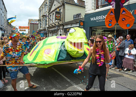 Amici, famiglie e scuole sfilano per le strade di Penzance in Cornovaglia REGNO UNITO, su Mazey giorno, durante il Golowan Fesitval. Foto Stock