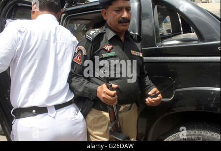 I funzionari di polizia scortare il veicolo durante il controllo di scatto e operazione contro lo schermo nero documenti incollati su windows di vetture, all Hotel Metropole a Karachi il mercoledì 25 maggio, 2016. Foto Stock