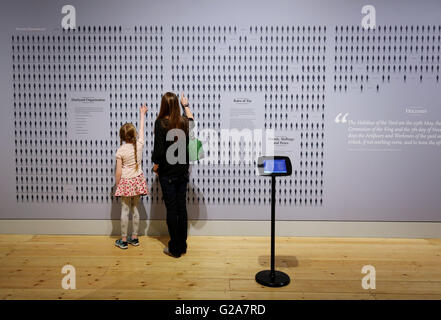 Una madre e figlia visualizza una scheda con i nomi e pagare le tariffe di tutte le persone che hanno lavorato a Chatham Dockyard il 31 marzo 1803, durante la stampa anteprima del nuovo 'comando degli oceani" Gallerie, all'Historic Dockyard Chatham, Kent. Foto Stock