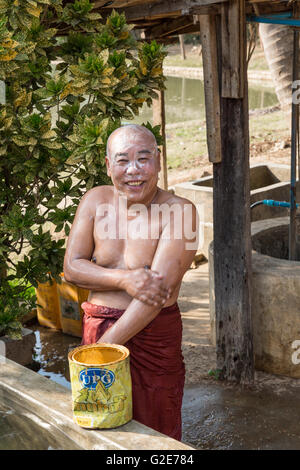 La vita quotidiana all'interno del monastero con Monaco durante la doccia, Myanmar, Mandalay Mingun, Birmania Foto Stock