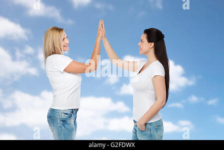 Gruppo di felice diverse donne in bianco t-shirts Foto Stock