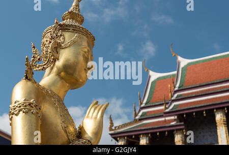 Statua dorata della divinità mitiche Kinnorn (Kinnara) nella parte anteriore del Pantheon Reale al Wat Phra Kaew tempio, il Grand Palace, Bangkok, Tha Foto Stock