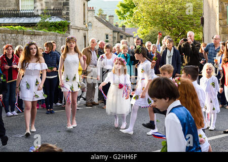 Il Castleton, Derbyshire, Regno Unito. Il 30 maggio 2016. Ghirlanda antica cerimonia anche se le strade di Castleton in Peak District . La Ghirlanda' è di per sé un alveare a forma di testa-abito, ricoperti di fiori selvatici e verde, che viene indossato dal re sopra la sua testa e spalle. Il primo, pezzo rimovibile del Garland è conosciuta come la "regina" ed è anche una piccola forma di alveare. La Ghirlanda spesso pesa tra 50 e 60 libbre e è molto pesanti da trasportare su del re sulle spalle. Il re e la sua consorte sono vestito in costume di Stuart - un collegamento con il primo Oak Apple giorno. Credito: Ian Francesco/Alamy Li Foto Stock