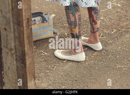 Tatuato le gambe di un pinup style donna Foto Stock