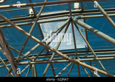 Vista dal basso della moderna tetto di vetro nel quartiere degli affari in serata con il vetro rotto Foto Stock