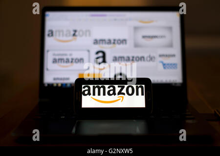 Amazon rivenditore online loghi sono presenti sul telefono e gli schermi dei notebook. Foto Stock