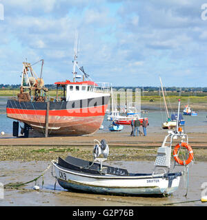 Barche in bassa marea il paesaggio costiero a West Mersea sulla Mersea Island presso la foce del fiume Blackwater vicino a Colchester Essex England Regno Unito Foto Stock