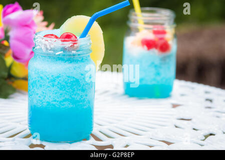 Blu bevande cocktail seduti su un tavolo bianco in un barattolo di mason Foto Stock