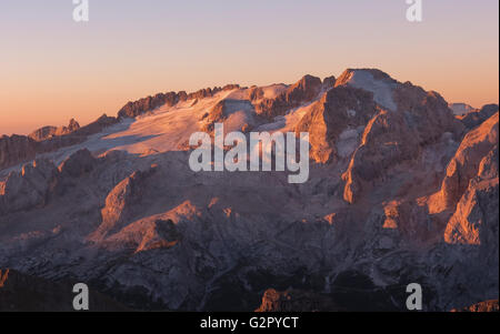 Alpenglow al tramonto sul gruppo Marmolada, il lato nord con il ghiacciaio. Punta Penia. Le Dolomiti. Alpi Italiane. Europa. Foto Stock