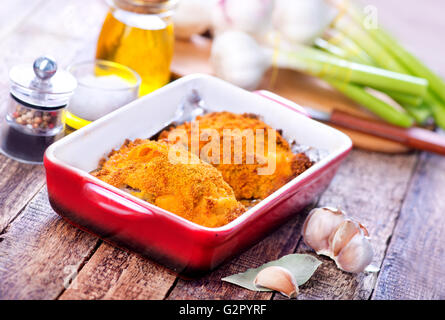 Pollo fritto in un recipiente e su un tavolo Foto Stock
